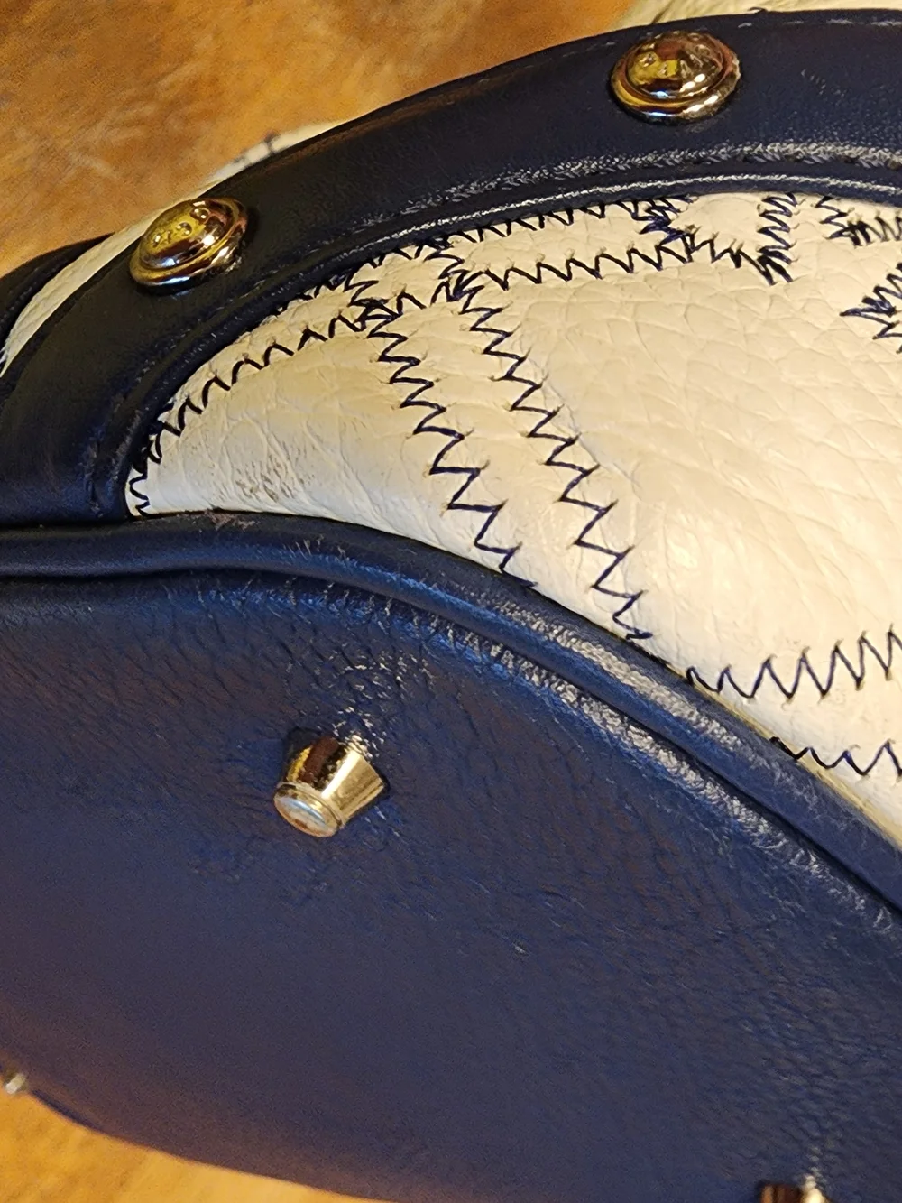 Metrocity leather handbag in white and navy with a quilted monogram pattern